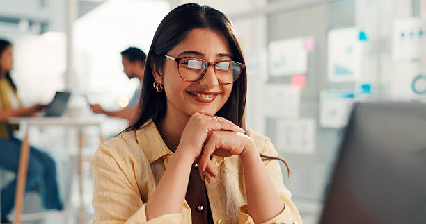 istock Woman, computer and happy at startup, feedback and project management with job at digital agency. Person, smile and pc for review, insight and glasses for results with web traffic increase at office 2255195546