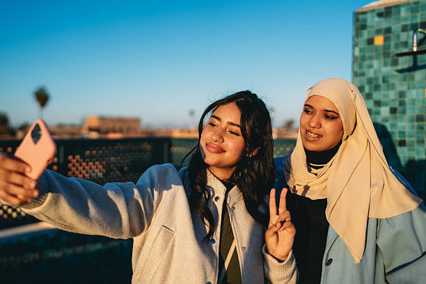 istock Young women taking selfie on rooftop in Morocco 2255196212