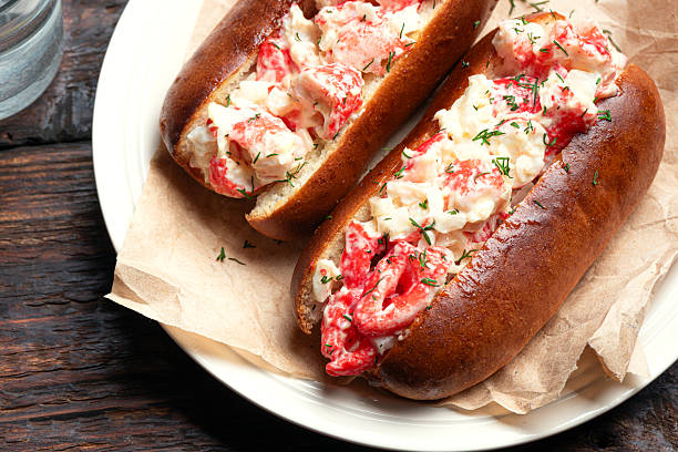 Lobster Roll. Traditional classic American Sandwich. New England meal. Fresh Maine Lobster with mayo and celery in toasted roll, close up, detailed.