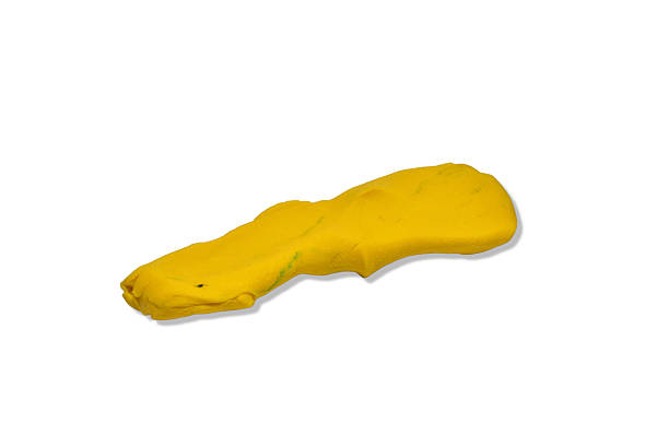 A piece of yellow plasticine for children isolated on white background.