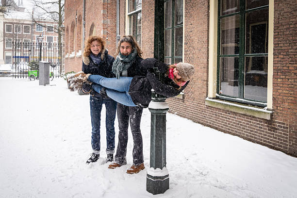 Group of female students having fun at Leiden University in the Netherlands in the snow
