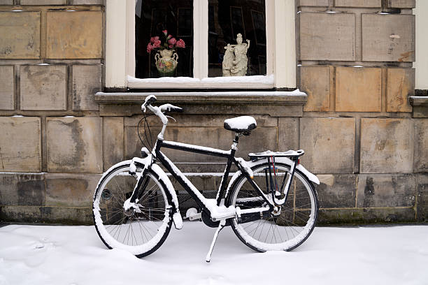 Snow-covered bicycles against an old house in the center of the university town of Leiden in the Netherlands