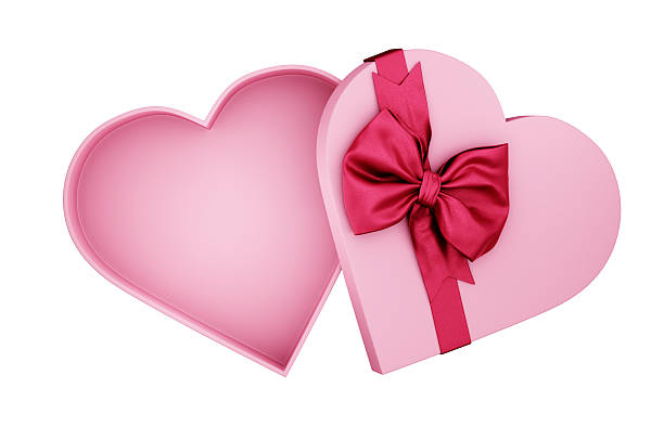 Pink heart shaped present box wrapped with red bow tie isolated on white background. Valentine's day giftbox for luxury product mockup. Mother's day, woman, birthday, anniversary holiday celebration.