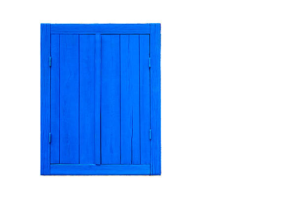 Blue window with closed wooden shutters on a white painted wall.