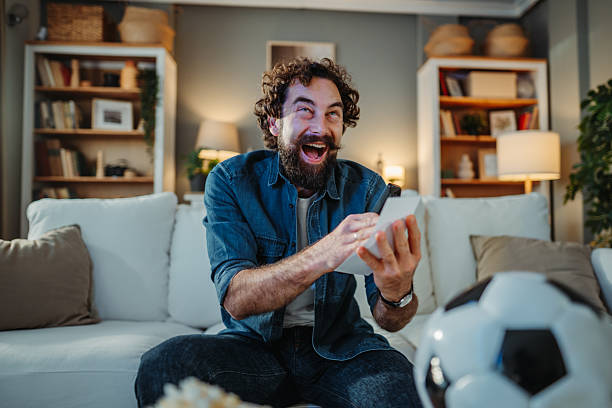 istock Excited man watching soccer match and celebrating victory 2255212025