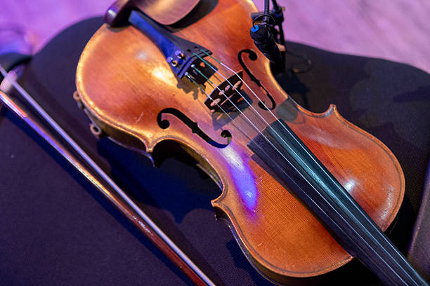 A violin lies on a chair on stage before a concert