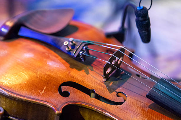 A violin lies on a chair on stage before a concert