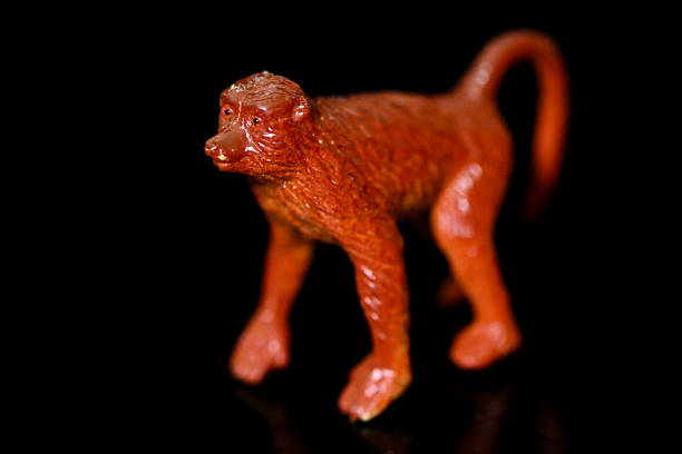 Toy Chimpanzee on a black glass background