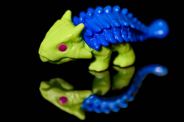 Plastic dinosaur toy on white background