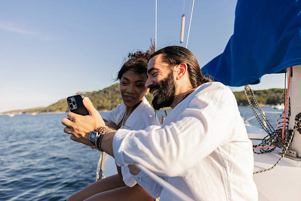 istock Couple taking selfie on sailboat during summer vacation 2255216276
