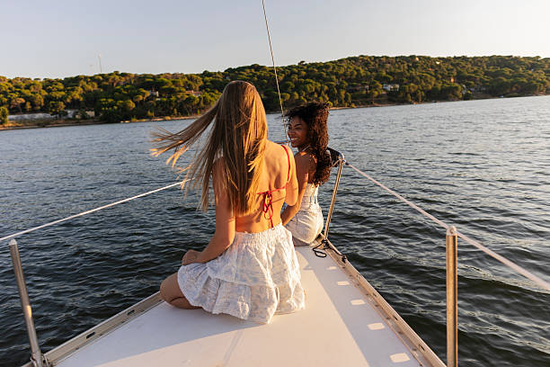 istock Two young women enjoying leisure sailing on a lake 2255216357