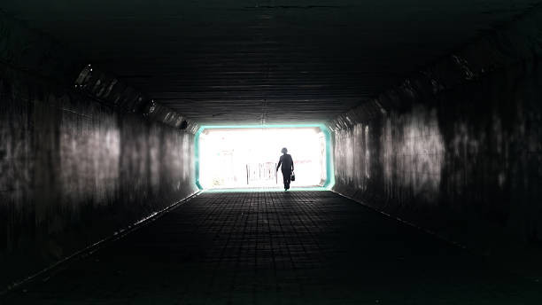 istock Silhouette of woman in dark underpass. 2255218741