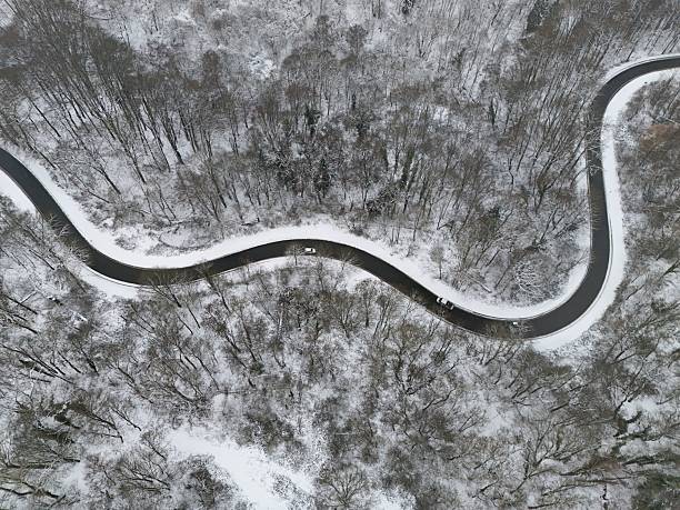 istock Winding Winter Road Through Snow-Covered Forest, Aerial View 2255222588