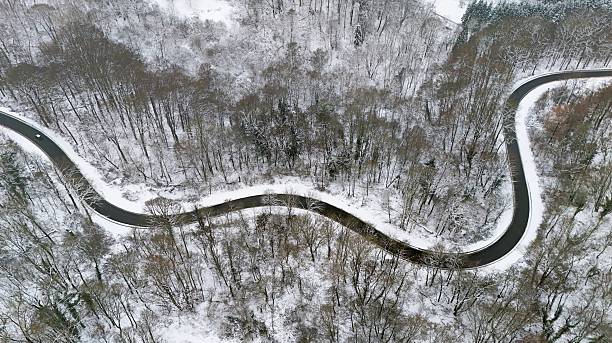 istock Winding Winter Road Through Snow-Covered Forest, Aerial View 2255222592