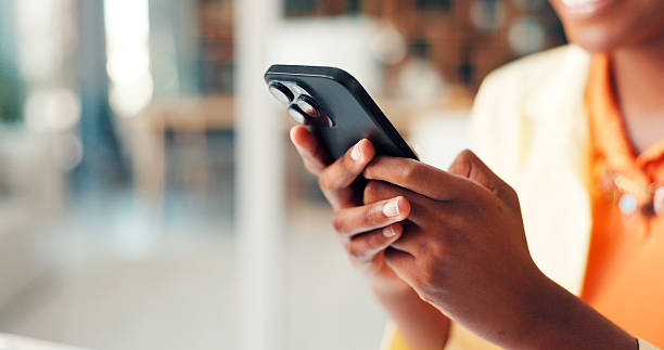 istock Texting, hands or woman in office with phone, schedule change or networking on digital app. Communication, space or employee in agency with tech, email update or message reply to stakeholder. 2255224463
