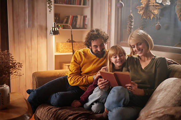 istock Family reading book together finding comfort at home 2255229623