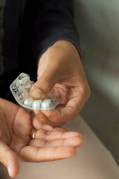 istock Medication Handling Moment with Pills 2255236124