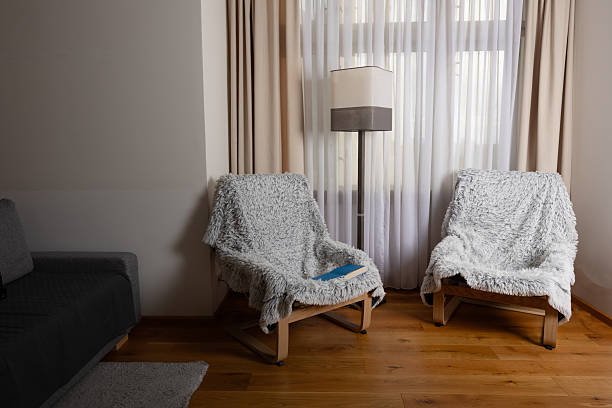 Cozy living room with two plush chairs and soft lighting by the window