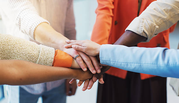 istock People, diversity or meeting with hands together for unity, trust or mission in office. Group, employees or multiracial team with pile, stack or huddle for community inclusion, solidarity or cohesion 2255238426