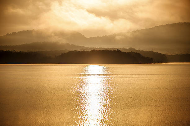 The quiet lake reflects the fading daylight and surrounding mountain forms