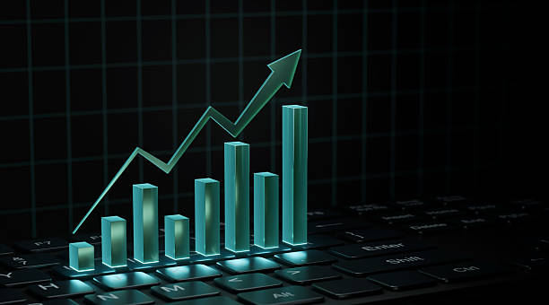 istock A glowing green 3D bar graph and an upward-pointing arrow rising from a computer keyboard, symbolizing financial growth and digital business success. 2255254093