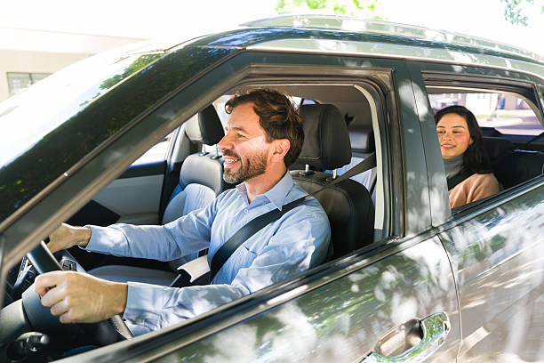 istock Rideshare driver transporting female passenger in car, providing convenient urban transportation service 2255260347