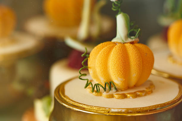 Delicate pumpkin-shaped dessert garnishes a festive fall collection of treats.