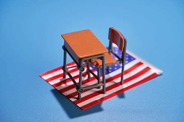 Miniature School Desk and School Bag on White Background