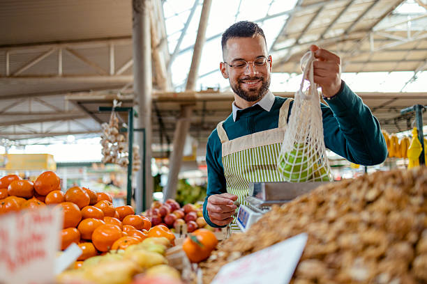 istock Stall Holder Selling Farm Fresh Fruit at Market 2255268975