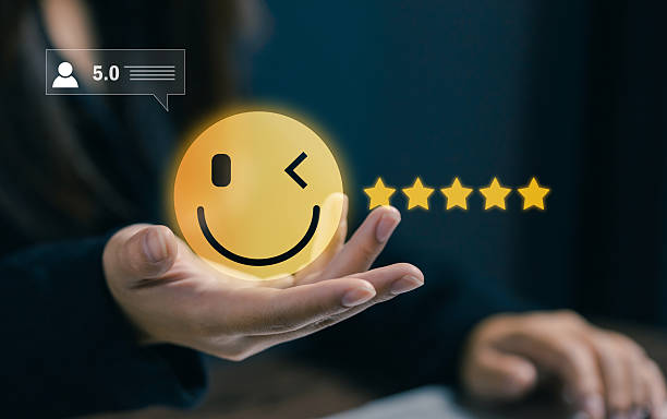 istock Smiling emoticon with five star rating floating above a hand, representing customer satisfaction, positive feedback, online reviews, service quality, and excellent user experience in digital platforms 2255269334