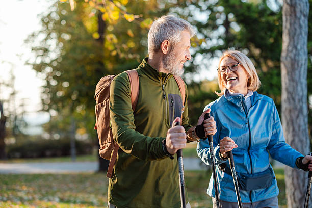 istock Mature couple enjoying Nordic walking outdoors in a park, smiling, active, and content 2255269729
