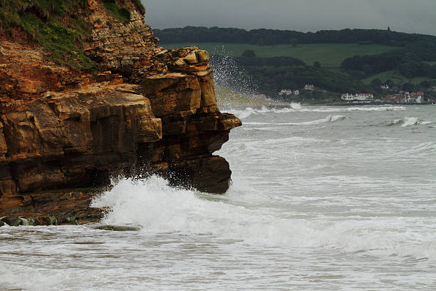 The wild sea is hitting the rocks that form the coastline of Whitby, Yorkshire