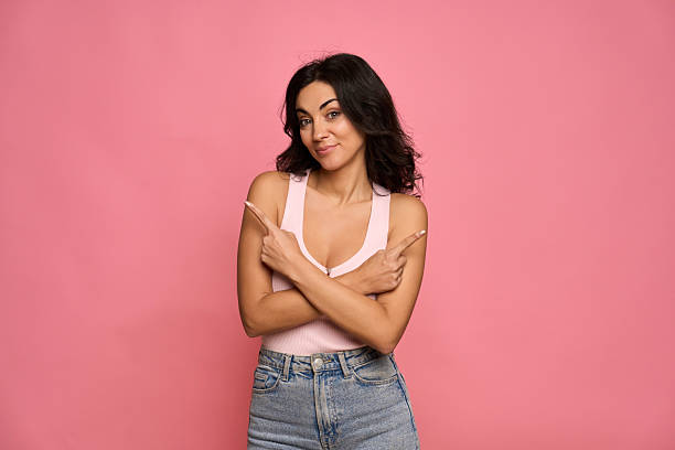 istock Young woman making a decision pointing in opposite directions 2255274572