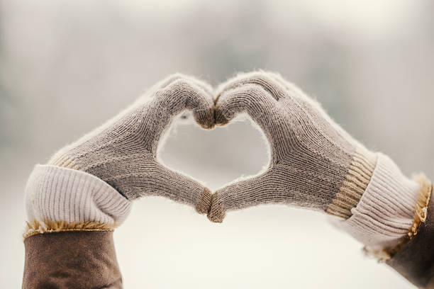 istock Hands in gloves forming heart shape in winter 2255277534