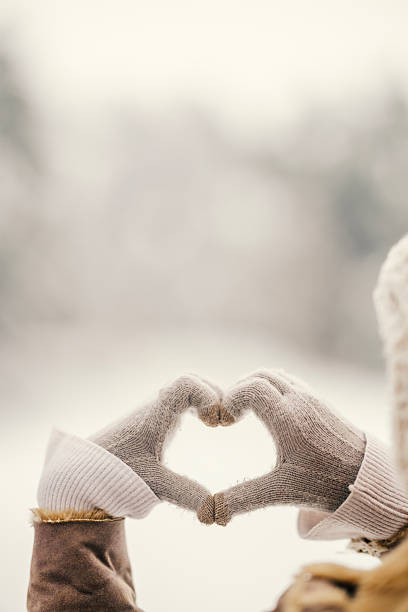 istock Hands in gloves forming heart shape during winter 2255277552