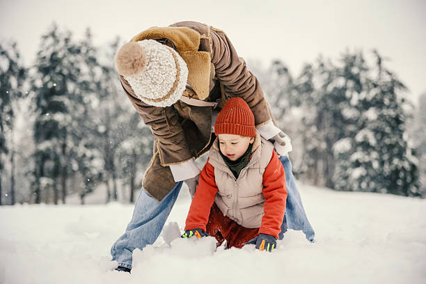 istock Mother and child playing in fresh snow during winter 2255277908