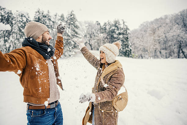 istock Young couple enjoying winter fun in a snow fight 2255277958