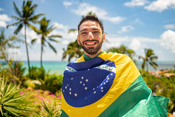 Man waving the Brazilian flag at Carnaval in Olinda, Pernambuco, Brazil