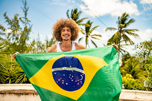Man waving the Brazilian flag at Carnaval in Olinda, Pernambuco, Brazil