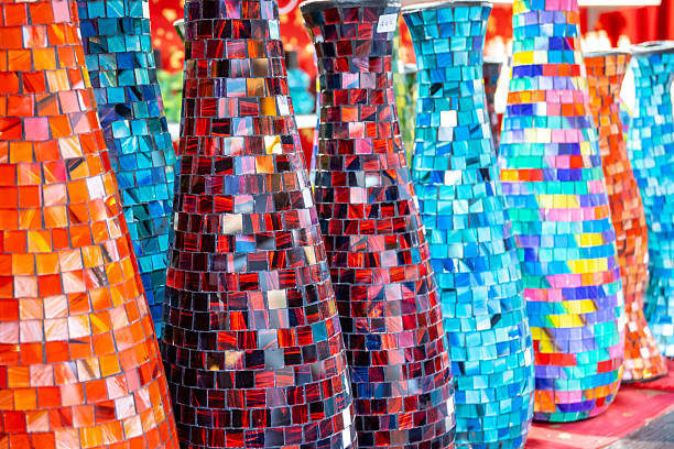 Colored glass vases with red, blue and multicolored mosaic. Art exhibition on the Christmas market. Handmade vase for interior.