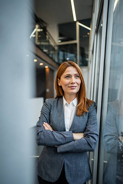 istock Confident business woman looking away in modern office 2255283143
