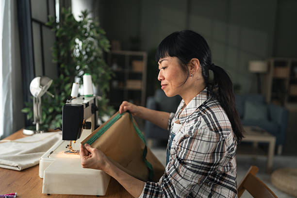 istock Woman sewing fabric using a sewing machine at home 2255285278