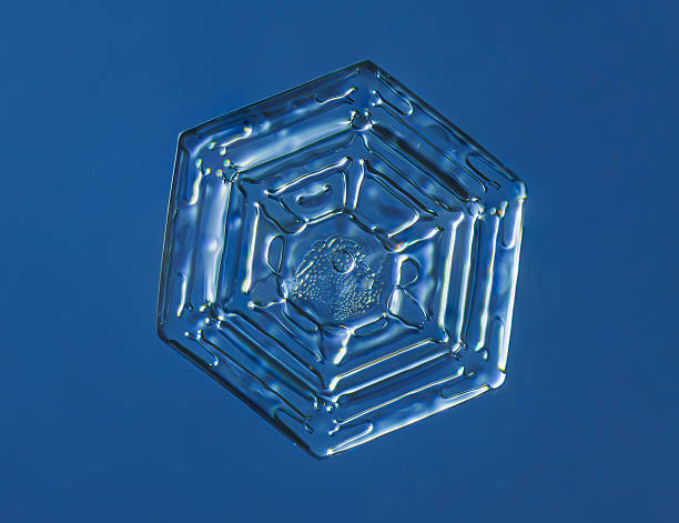 Natural snowflake crystal in blue background.