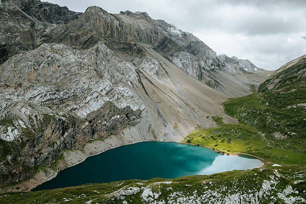 Elevated view of alpine lake and meadows, Verbier, Valais Canton