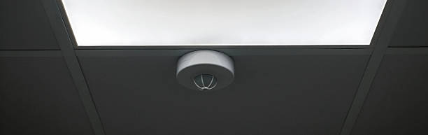 istock A fire detector mounted on a suspended ceiling next to a light fixture warns of danger and ensures occupational safety 2255295806