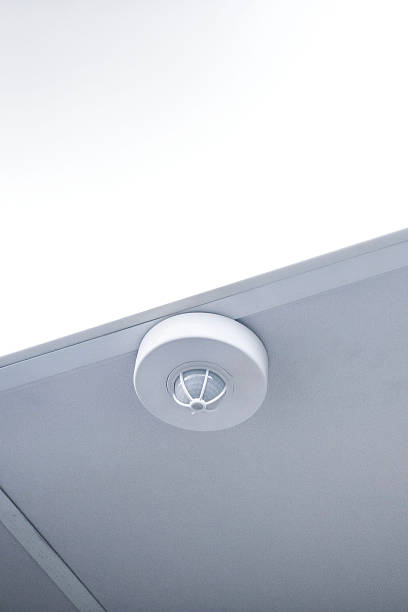 istock A fire detector mounted on a suspended ceiling next to a light fixture warns of danger and ensures occupational safety 2255295809
