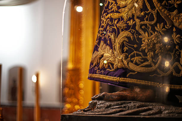 Close-up reveals ornate embroidery and carved detail of Nuestro Padre Jesus del Gran Poder, 17th-century religious icon in Seville, Spain.