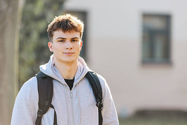 istock Young Man With Backpack In Casual Hoodie Standing Outdoors On Campus 2255298002