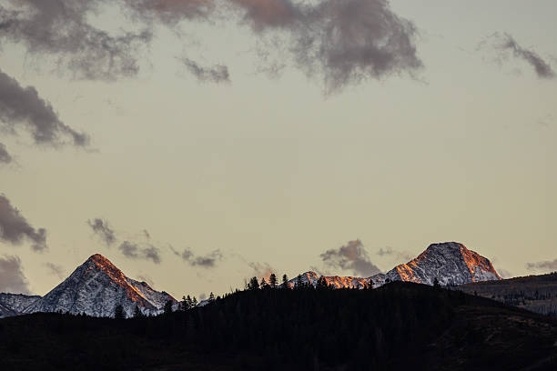 Beautiful Skyline at Sunset. Snow Covered Mountain Range and Whispy Clouds. Copy Space. Background