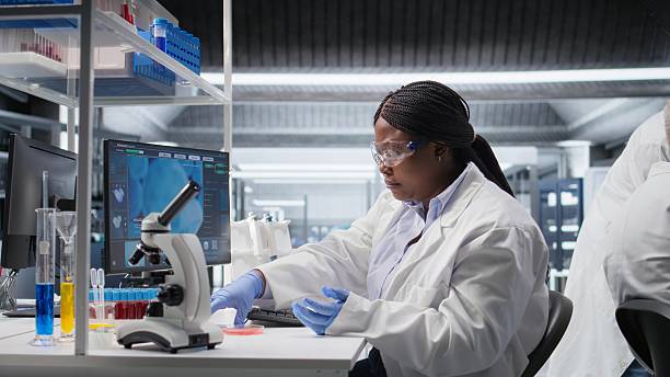 istock Scientist analyzes bacterial growth in Petri dish sample for lab research 2255304587